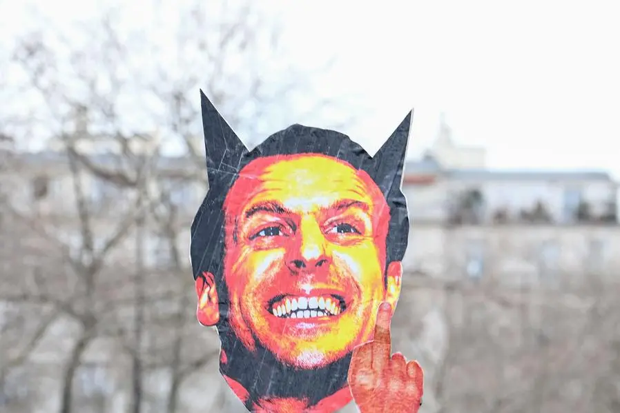 Protestors hold an effigy of French President Emmanuel Macron, during a demonstration on the 8th day of strikes and protests across the country against the government\\'s proposed pensions overhaul in Paris on March 15, 2023. - France faces another day of strikes over highly contested pension reforms which President appears on the verge of pushing through despite months of protests. As the legislation enters the final stretch in parliament, trade unions are set to make another attempt to pressure the government and lawmakers into rejecting the proposed hike in the retirement age to 64. (Photo by Alain JOCARD / AFP) , Agence France-Presse (AFP)/AFP