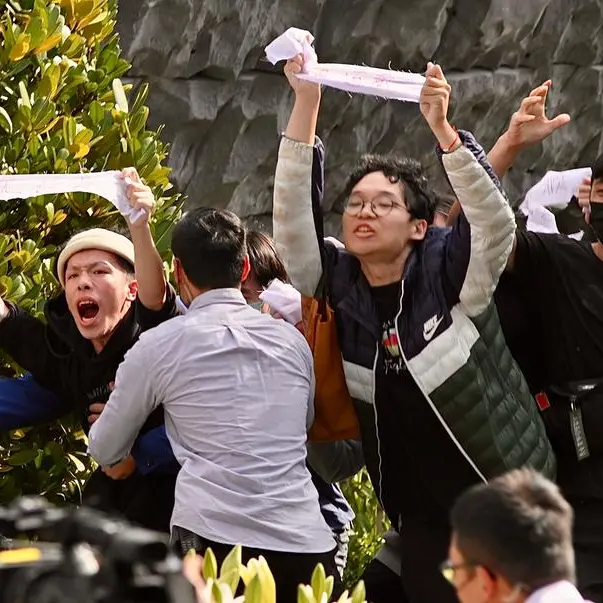 Protesters storm stage at Taiwan massacre memorial