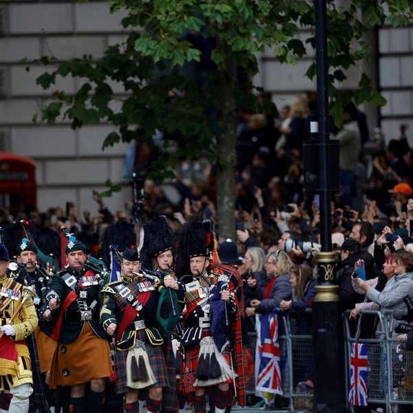 With flags and flasks of tea, huge crowds await Queen's funeral