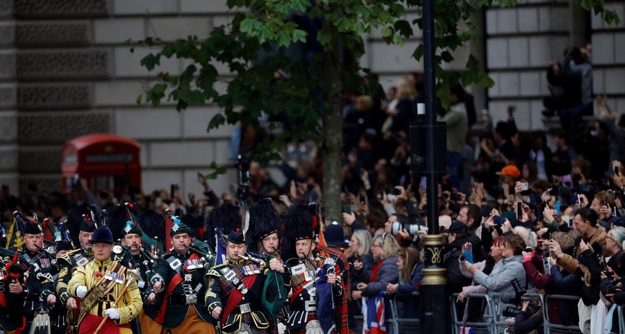 With flags and flasks of tea, huge crowds await Queen's funeral