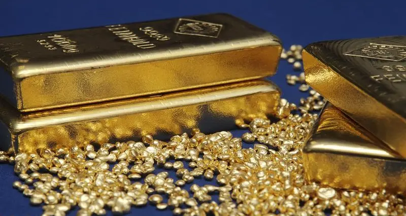 Gold holds near one-week low on firmer dollar, higher yields