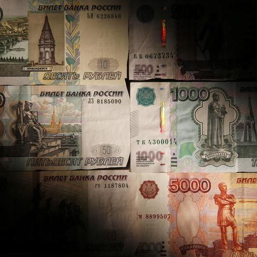 Russian rouble slips towards 61 vs dollar while shares edge lower