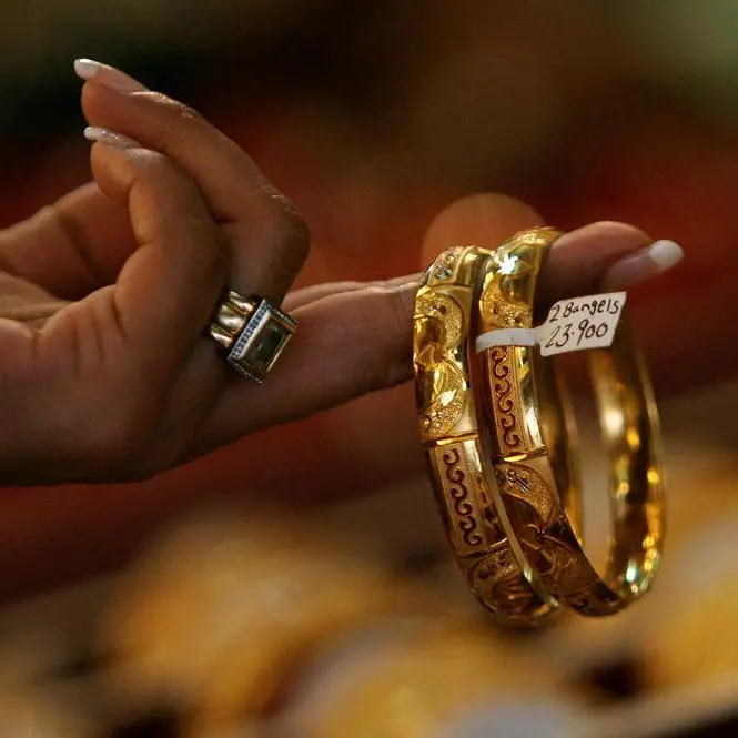 Gold climbs as weaker dollar, safe-haven demand lend support