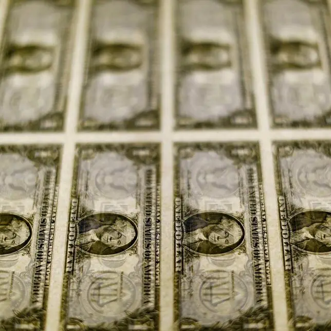 Dollar edges higher, buoyed by monetary policy imbalance