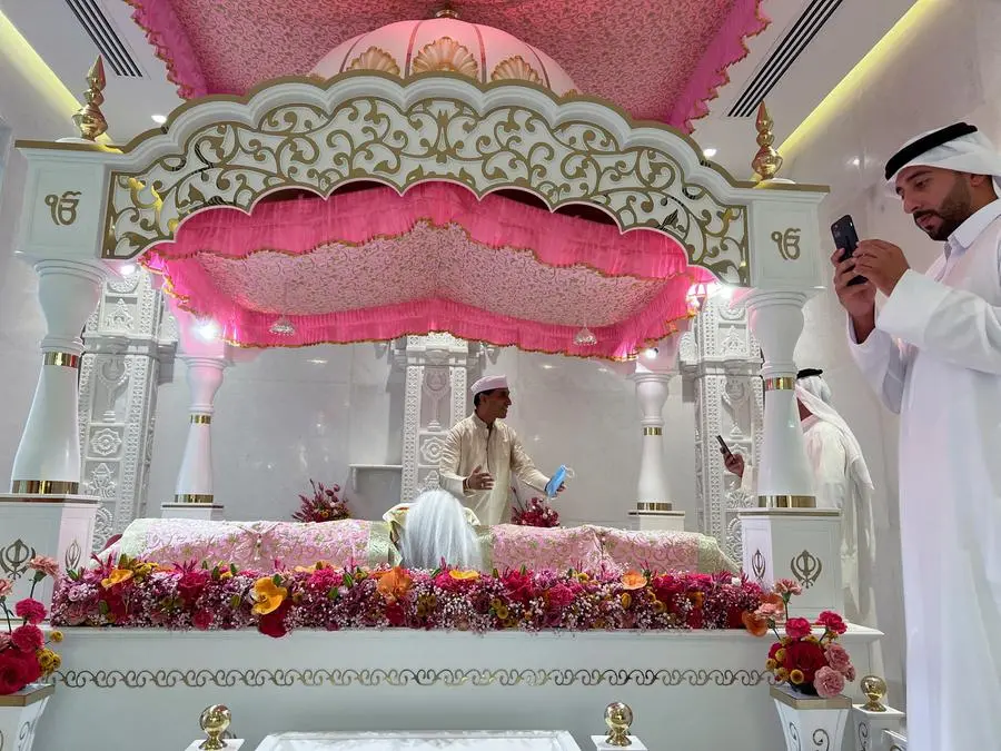 A visitors holds a mobile phone at the newly inaugurated Hindu Temple in Dubai, United Arab Emirates, October 4, 2022. REUTERS/Rula Rouhana
