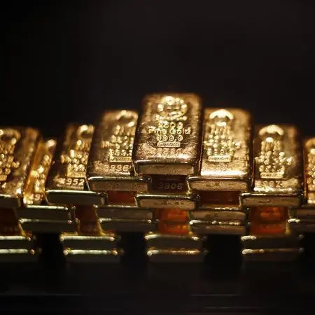 Gold firms on dollar slide; market focus on Fed minutes