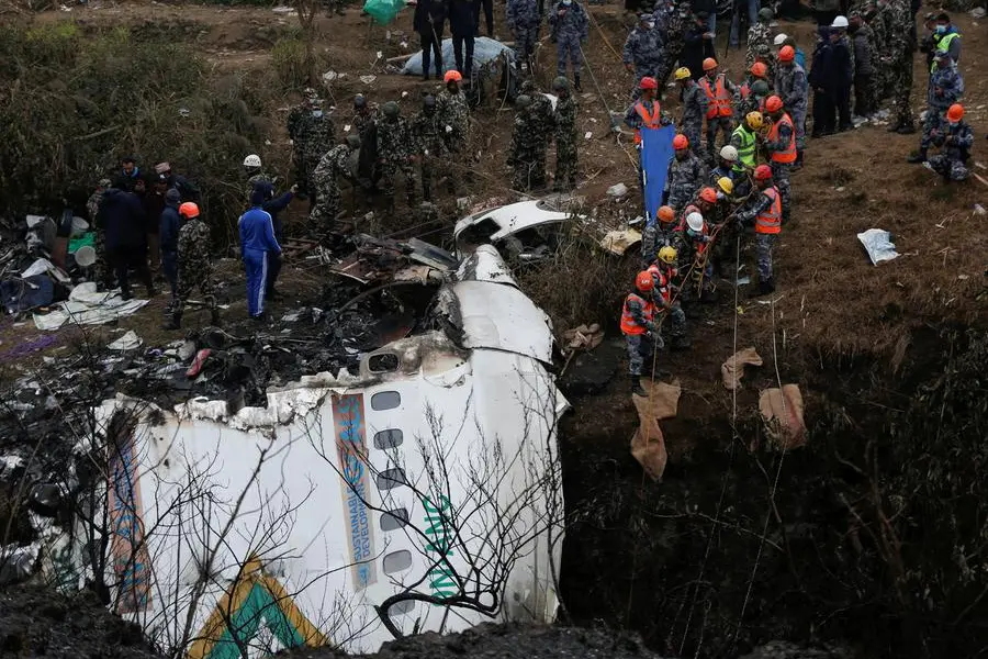 Nepal plane crash searchers rappel, fly drones to find last passengers