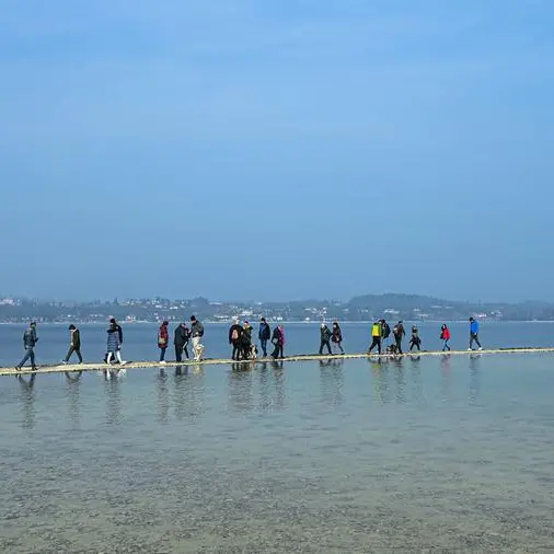 Lake Garda tourists flock to island reconnected by drought