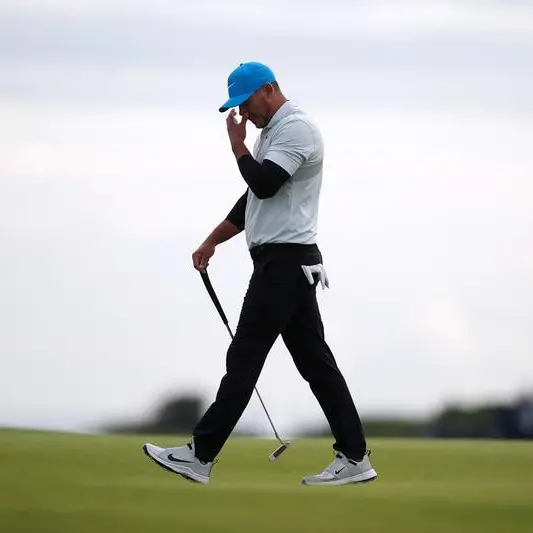Koepka storms into Masters lead before weather halts play