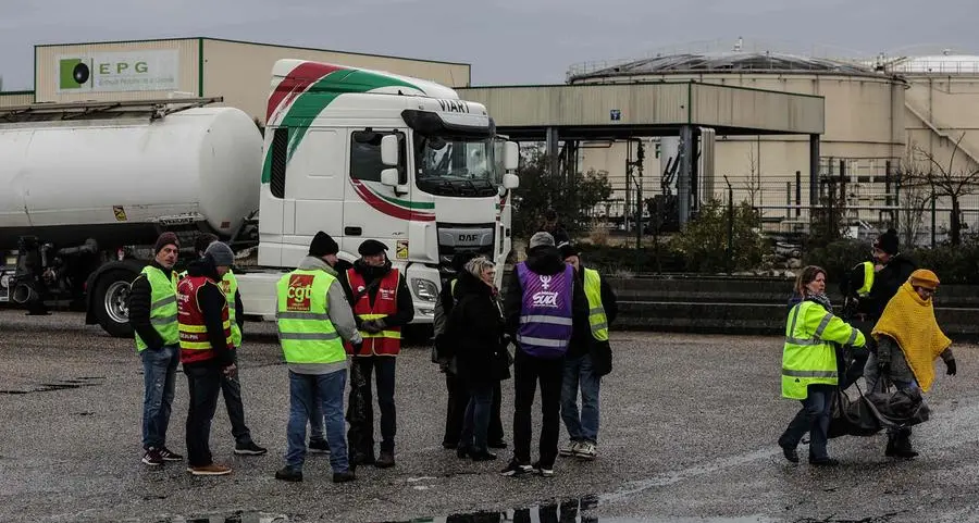 French roads blocked, refineries on strike after Macron pension move