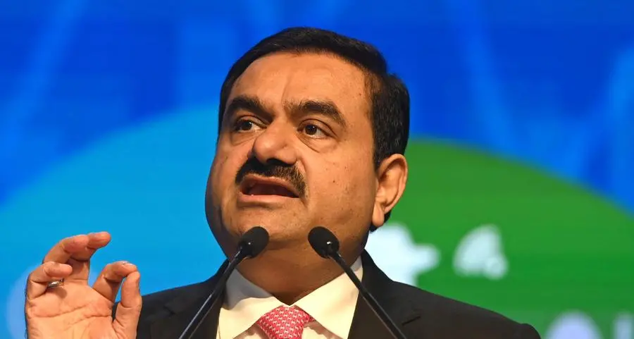 Shares in India's Adani plunge 15%, triggering trading halt