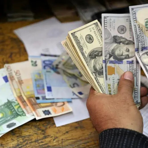 Dollar jumps, euro dips before Fed minutes