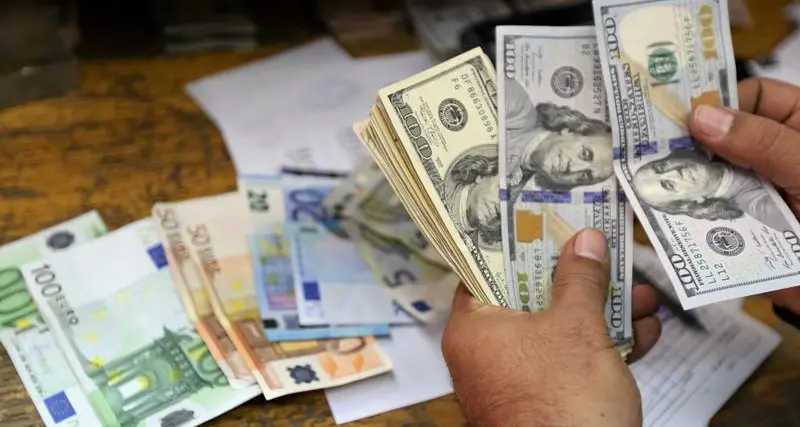 Dollar jumps, euro dips before Fed minutes