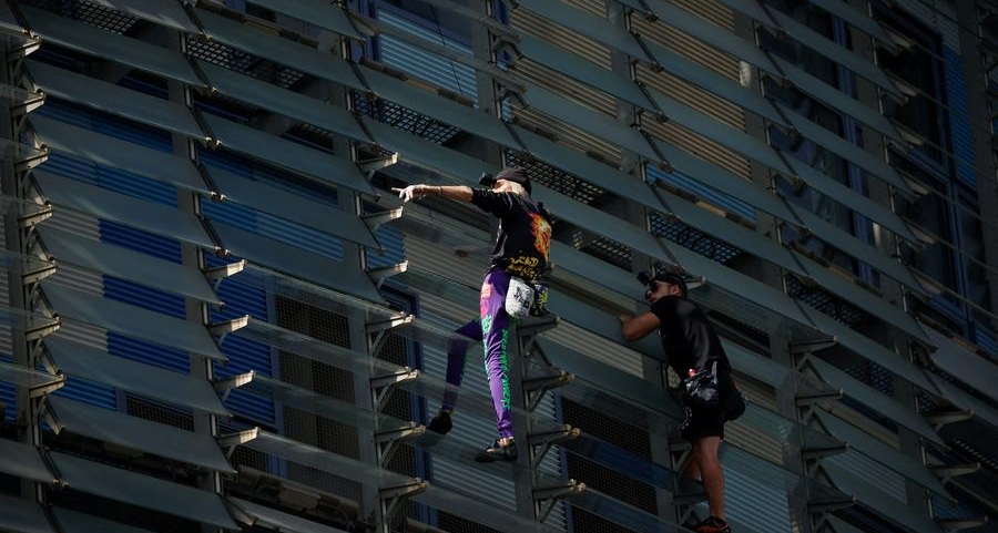 'French Spiderman' climbs first skyscraper with son in Barcelona
