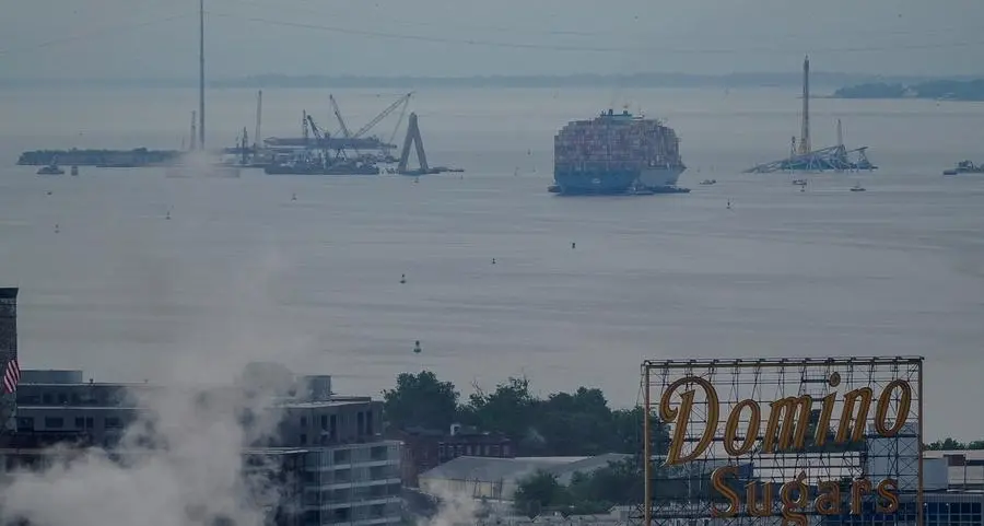 Crashed ship that took down Baltimore bridge refloated, towed from channel