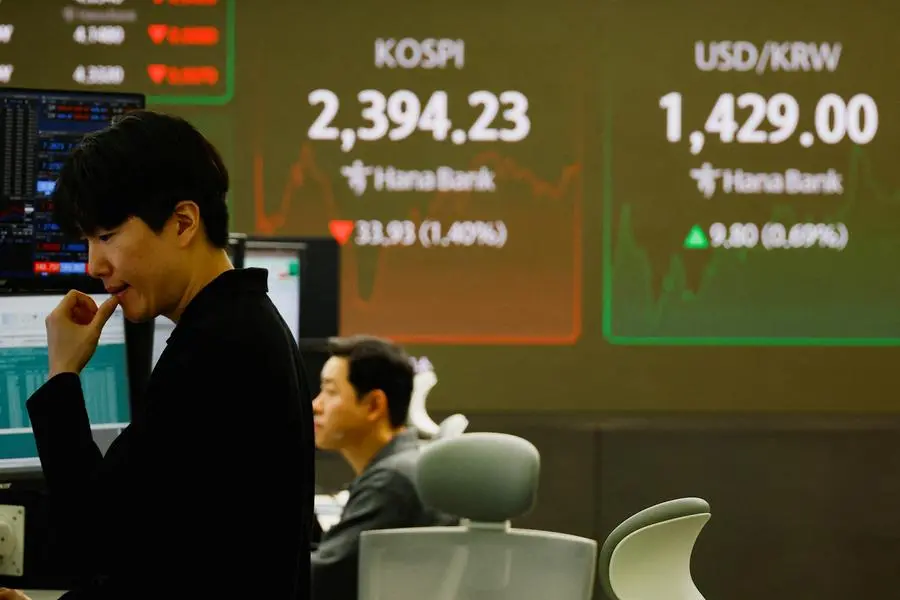 Currency dealers work in front of electronic boards showing the Korean Composite Stock Price Index (KOSPI) and the exchange rate between the U.S. dollar and South Korean won at a dealing room of a bank, in Seoul, South Korea, December 9, 2024. REUTERS/Kim Kyung-Hoon. , Reuters