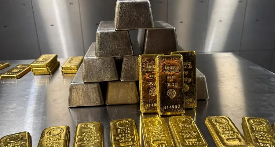 Gold edges down on profit-taking; silver at record high