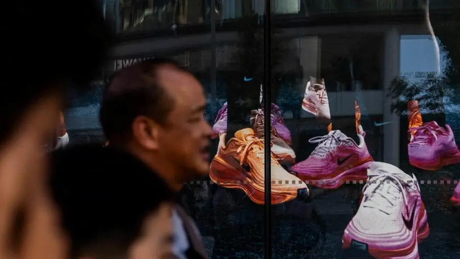 Futures edge higher on tech rebound, Nike slumps on China pain