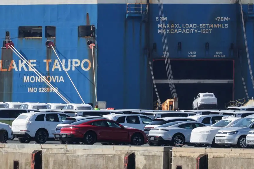 FILE PHOTO: A Volkswagen Group car is loaded into a cargo ship as Porsche luxury and other VW cars intended for the export to the United States wait to be loaded at the seaport of Emden near the estuary, where the River Ems flows into the North Sea, in Emden, Germany, April 2, 2025. REUTERS/Wolfgang Rattay/File Photo , Reuters/REUTERS