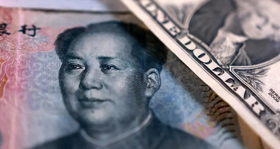 China state-owned banks soak up dollars to slow yuan gains, sources say