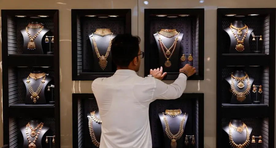 Gold prices slide further as dollar firms, investors book profits