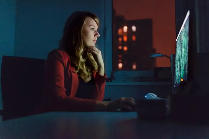 Side view of businesswoman Working on a PC at night writing programming code. Pretty woman worker programmer using computer working in office and typing coding developed new online system. selective focus photo. Photo of of a hacker female person typing at a keyboard with matrix effect on computer monitor. , Getty Images/Getty Images