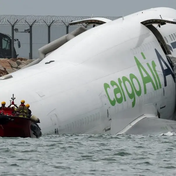 Cargo plane slides off runway in Hong Kong, killing two airport staff