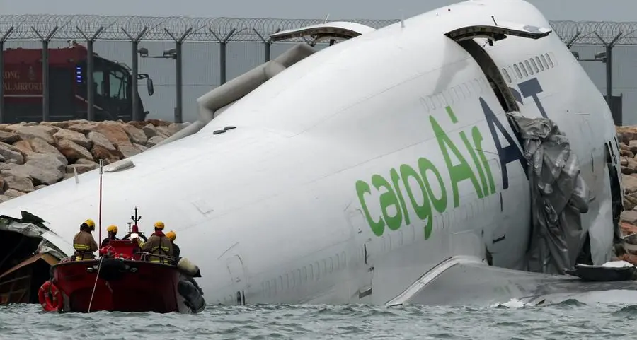 Cargo plane slides off runway in Hong Kong, killing two airport staff
