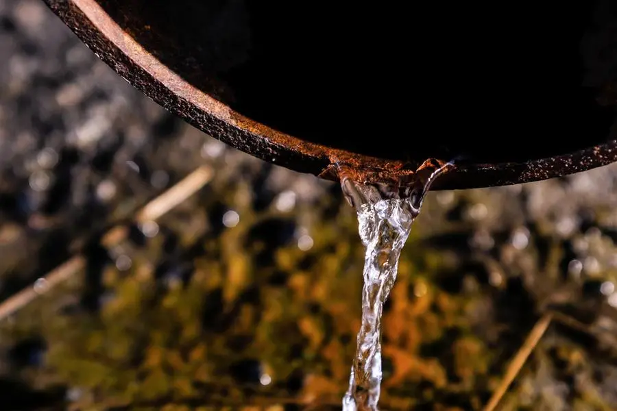 A stream of crystal clear water flows, falling from the drain pipe to the ground and sidewalk. Rain water flowing out of the drainpipe close-up. The onset of spring, melting snow, the first rain. , Getty Images/Getty Images