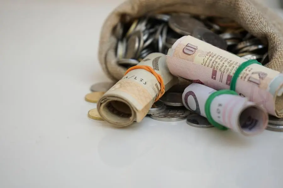 Close up shoot for saudi riyal and coins in sacks bag. Image used for illustrative purpose. Getty Images , Getty Images