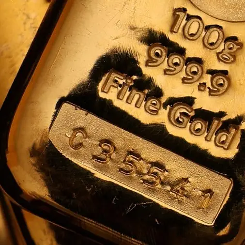 Gold declines on thin trading, stronger dollar