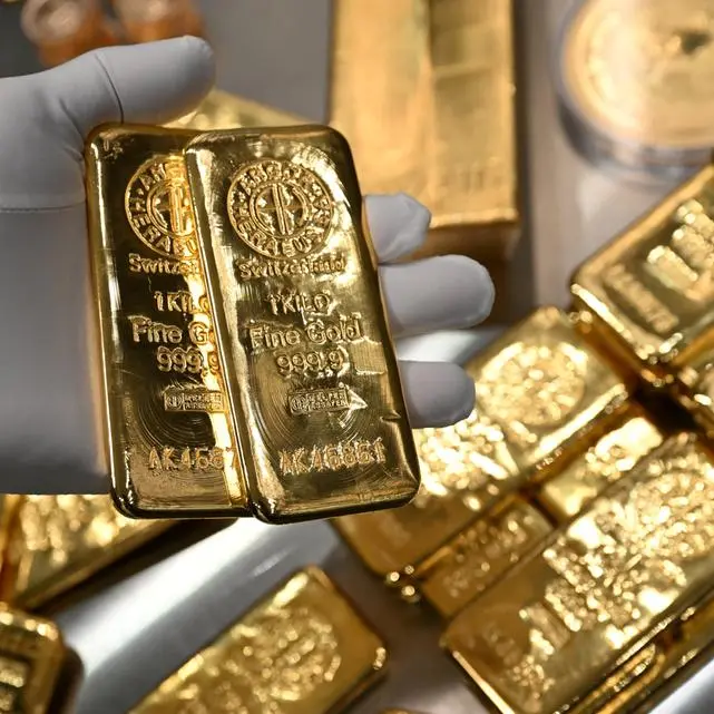 Gold falls as firmer dollar adds to pressure of softened US trade stance