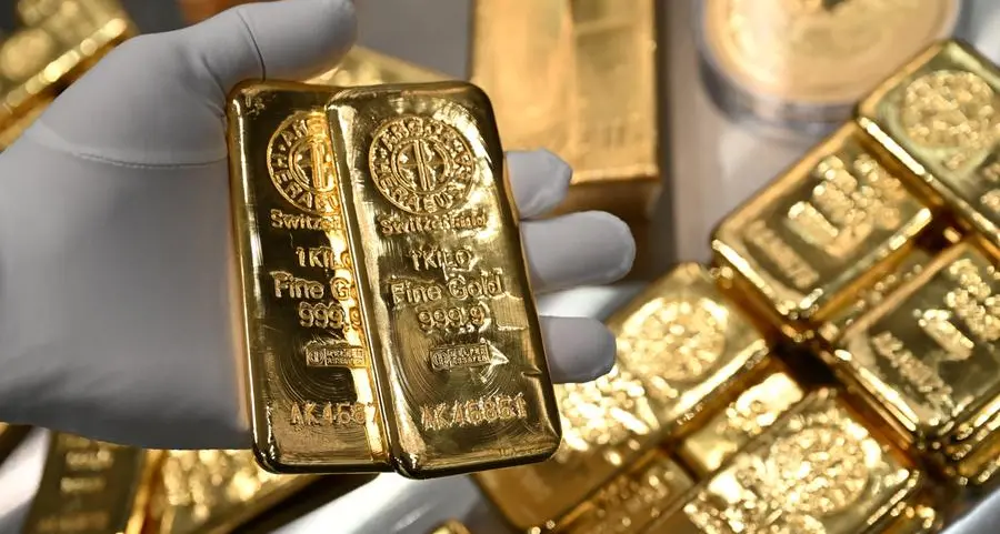 Gold falls as firmer dollar adds to pressure of softened US trade stance
