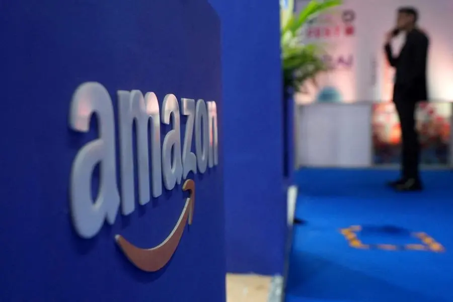 FILE PHOTO: A visitior stands near a logo of Amazon during the annual Retail Leadership Summit in Mumbai, India, February 27, 2025. REUTERS/Hemanshi Kamani. , Reuters