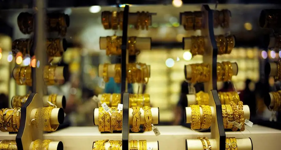 Gold dips as dollar firms, investors weigh US rate outlook