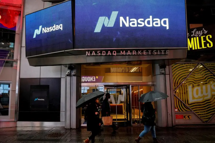 FILE PHOTO: People pass by the Nasdaq Market Site in Times Square in New York City, U.S., February 7, 2018. REUTERS/Brendan McDermid. , Reuters