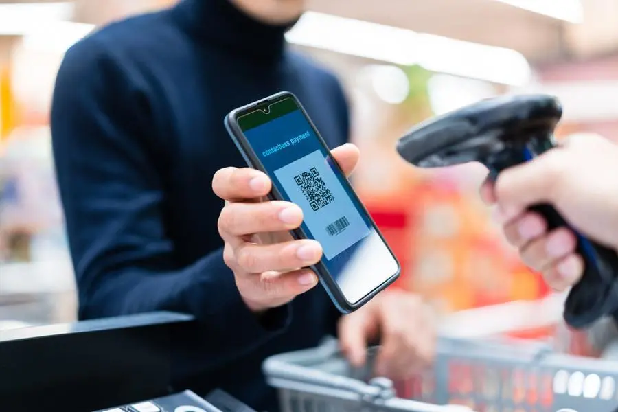 Asian man contactless payment with qr code in supermarket. Image used for illustrative purpose. Getty Images , Getty Images