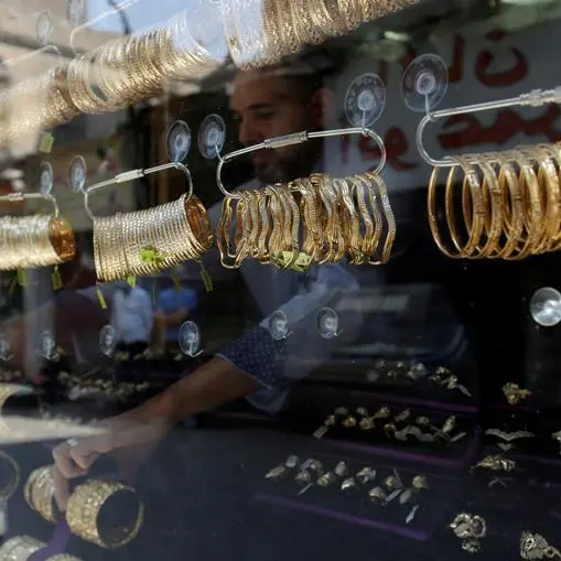 Gold retreats from near four-week high as dollar gains; investors stay cautious