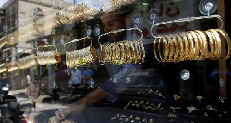Gold retreats from near four-week high as dollar gains; investors stay cautious