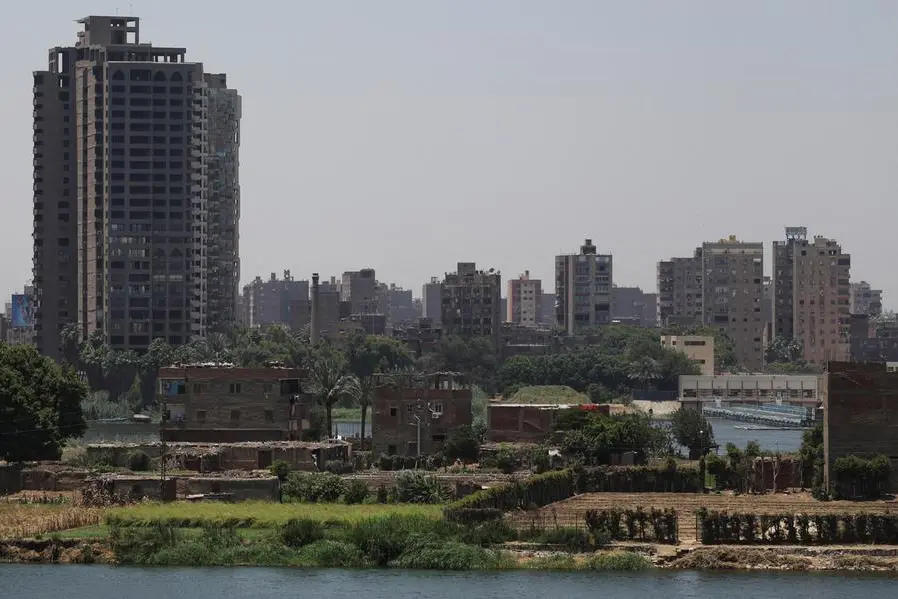 A general view of a farmland with houses on small island next to crowded residential buildings and bridges on the bank of River Nile, as continuous population growth and urban sprawl erode the banks of the River Nile, in Cairo, Egypt, May 22, 2025. REUTERS/Amr Abdallah Dalsh , Reuters/REUTERS