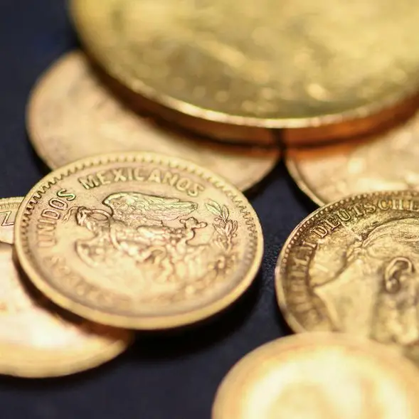 Gold lingers near 7-month low as Fed hike bets boost dollar