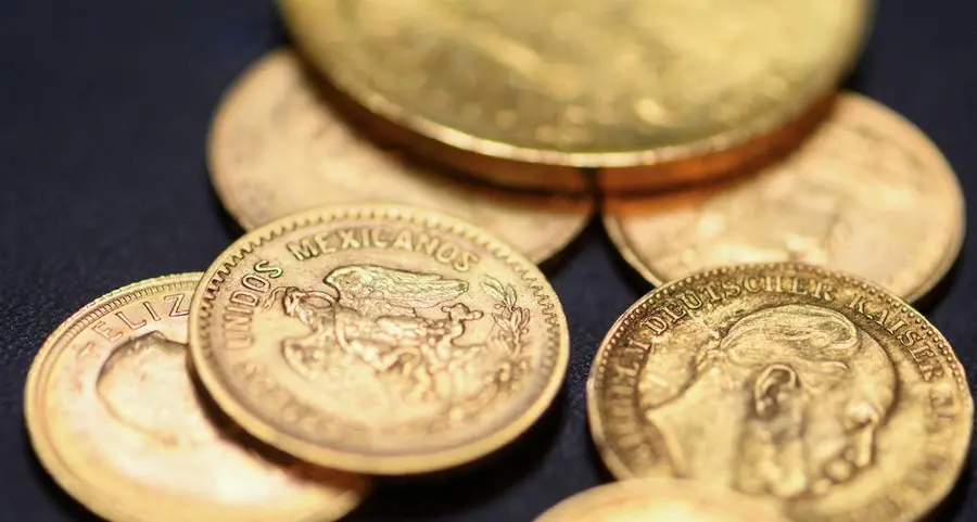Gold lingers near 7-month low as Fed hike bets boost dollar
