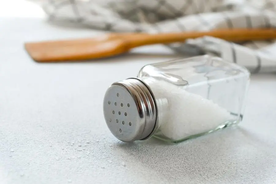 A new clean Wooden spatula, a kitchen towel and a salt shaker on the dining table. The concept of cooking in a restaurant and cafe, at home in the kitchen. Cook it yourself, taking courses on the ability to cook delicious and beautiful food. Copy space. Image used for illustrative purpose. Image courtesy: Getty Images/ Aleksandr Zubkov , Getty Images