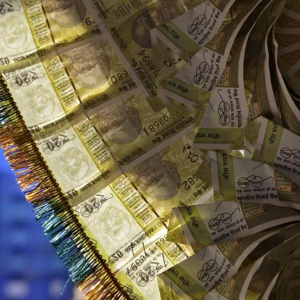 By Jaspreet Kalra slips to record low, but central bank likely curbs losses