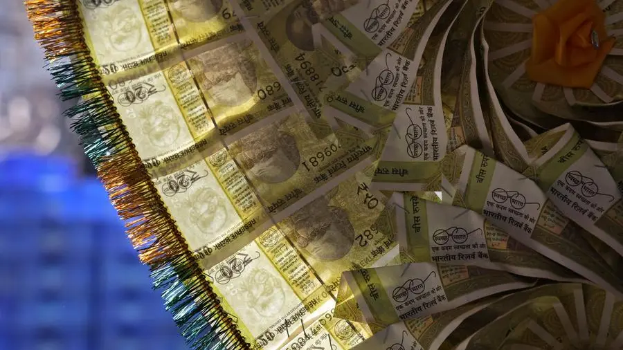 By Jaspreet Kalra slips to record low, but central bank likely curbs losses