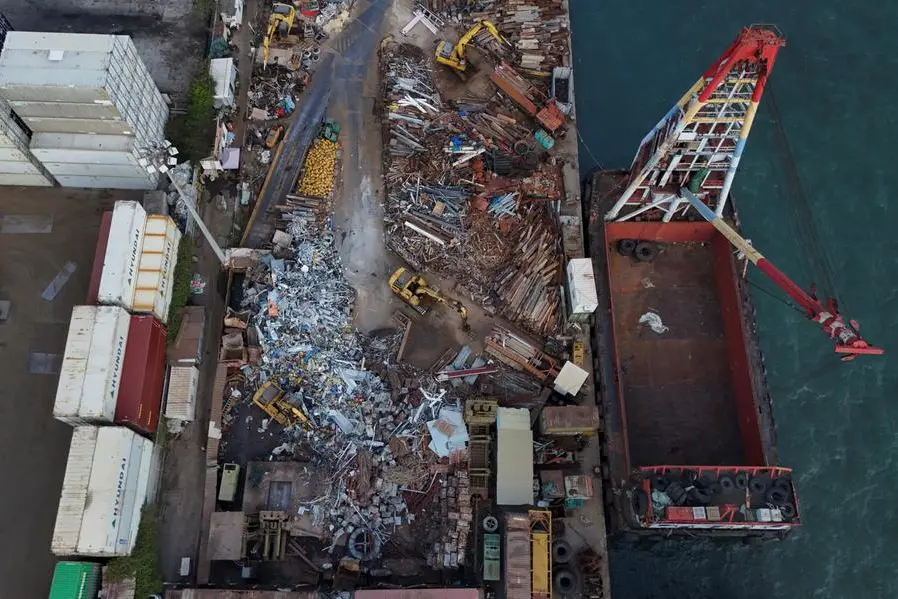 Excavators process scrap metal near a transport ship in Hong Kong, China, April 23, 2025. REUTERS/Tyrone Siu , Reuters/REUTERS