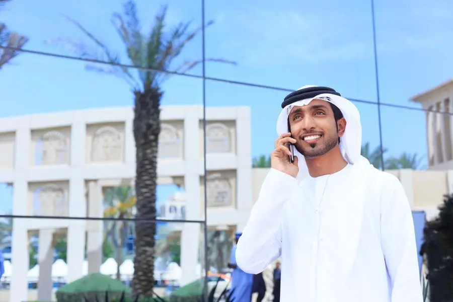A Handsome Arab Model Speaking In Phone Happy Smiling And Wearing UAE Traditional Dress. Image used for illustrative purpose. Image courtesy: Getty Images/ ValentinRossanov , Getty Images