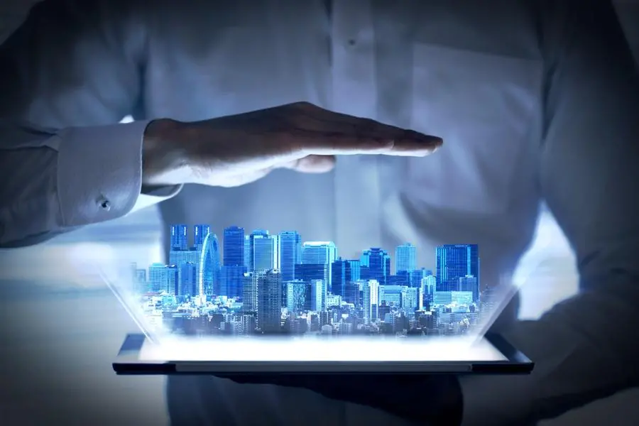 Holographic image of urban development that emerges from the tablet. Image used for illustrative purpose. Image courtesy: Getty Images/ Mapo