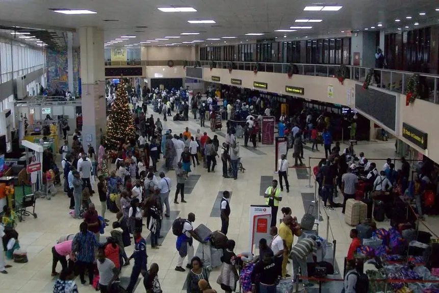 View Of Advertisement Sign, People Walking, Standing, Looking Around, Talking To One Another, Checking In Their Travelling Bag At Check In Counter And More At Murtala Muhammed International Airport Lagos State Nigeria. Image used for illustrative purpose. Getty Images , Getty Images