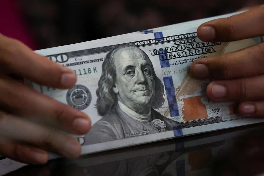 Dollar slips on caution over US economy, traders mull US-Japan talks